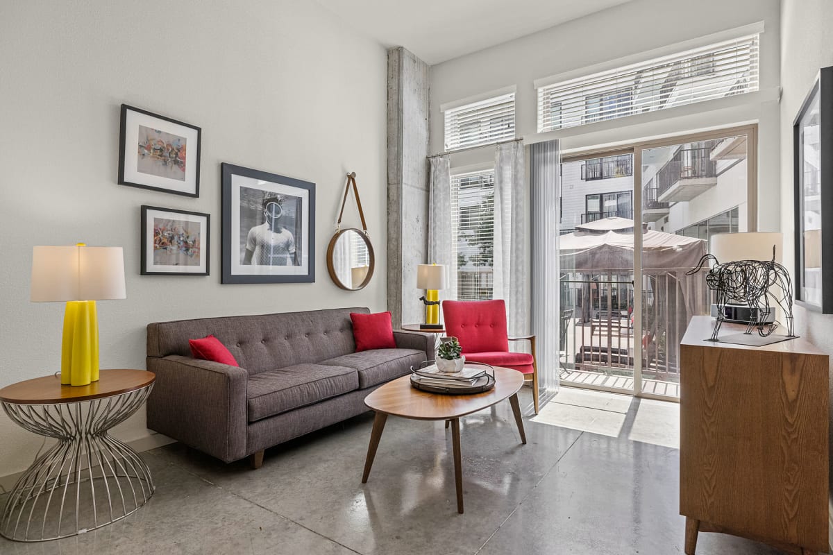 Bright living room with large sofa and modern furnishings at Marq on Burnet in Austin, Texas