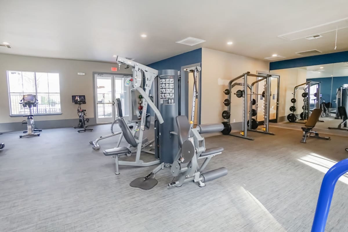 Free weights and pelotons in the Fitness Center at The Leonard in Denton, Texas