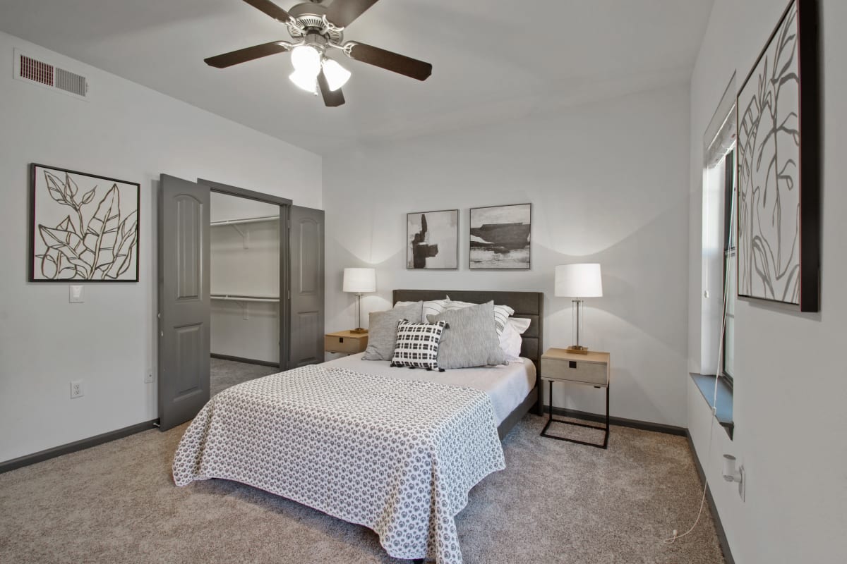 Model bedroom with gray accents at Marquis on Evans in San Antonio, Texas