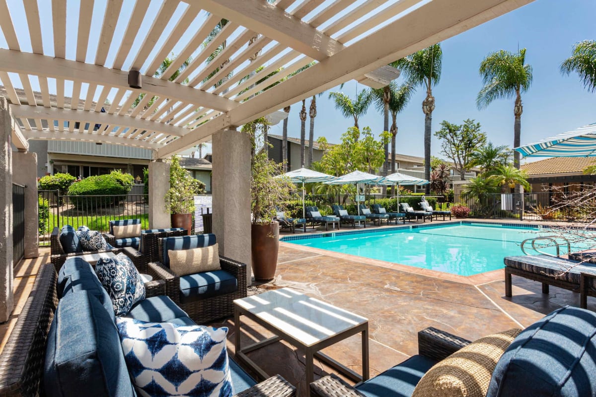 Patio seating by the swimming pool at Axiom Tustin in Tustin, California