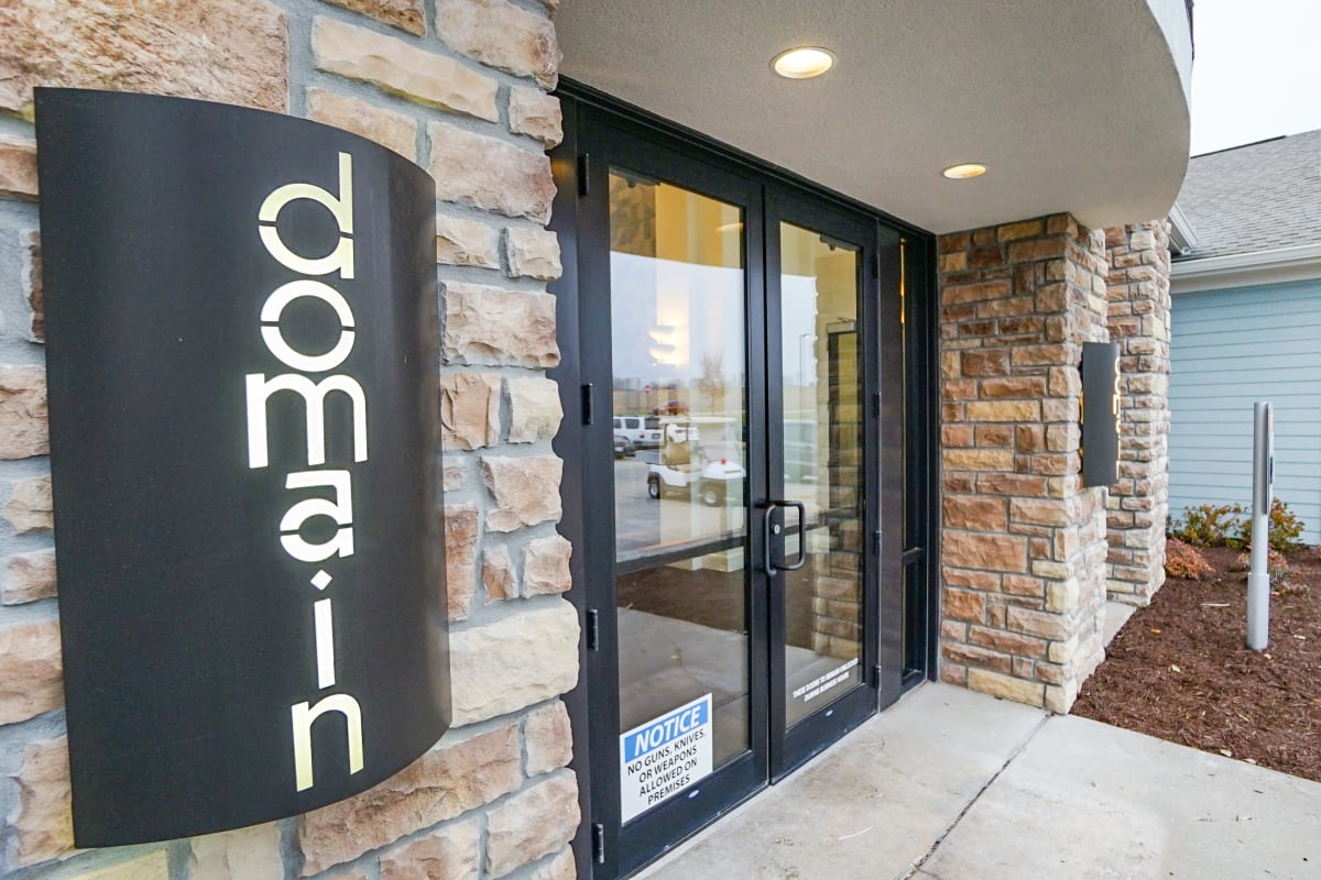 Main door entrance with location name at The Domain at Columbia in Columbia, Missouri