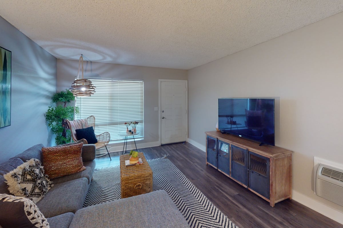 Open living room with wood-style flooring at Axiom Tustin in Tustin, California