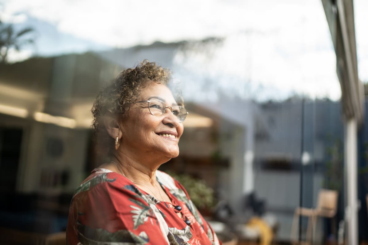 Resident smiling and enjoying the view looking out the window at Trustwell Living of West Knoxville in Knoxville, Tennessee