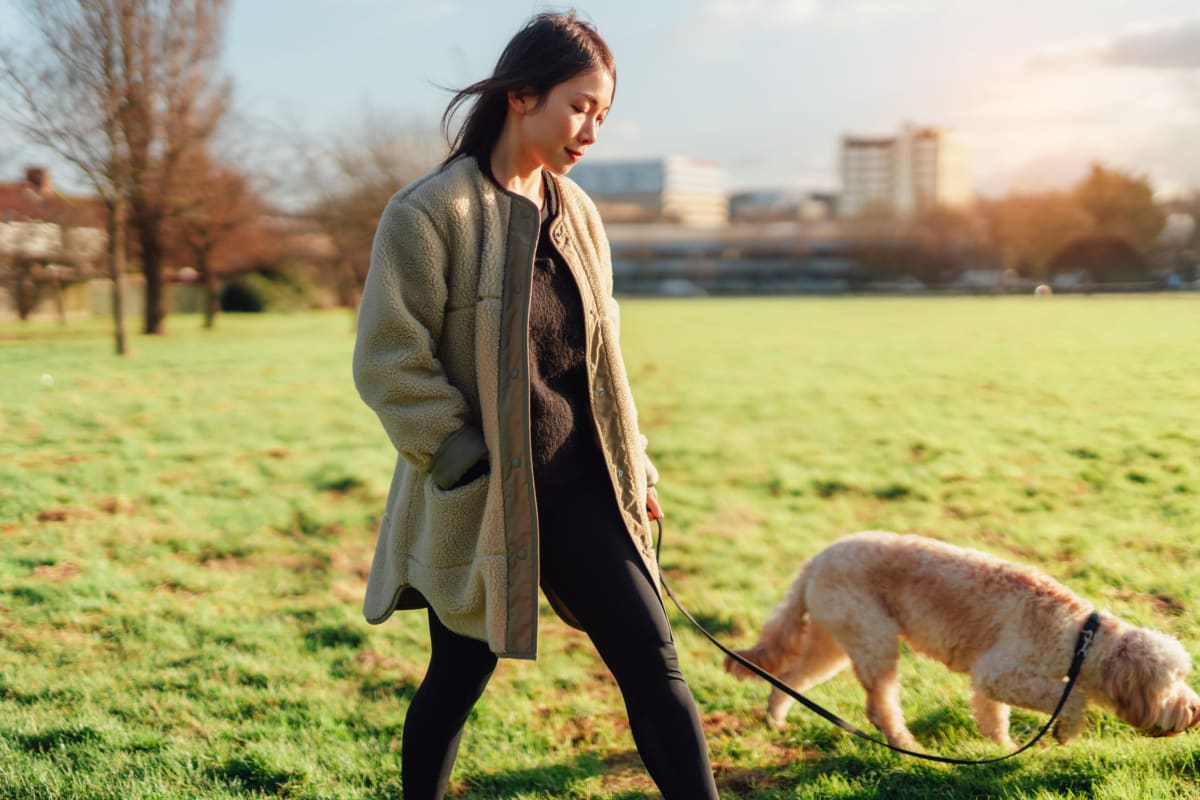 Resident and her dog on a walk near Neponset Landing in Quincy, Massachusetts