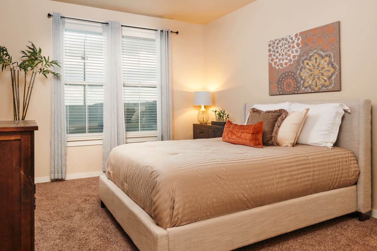 Modern bedroom with orange accents at Marquis Cross Mountain in San Antonio, Texas