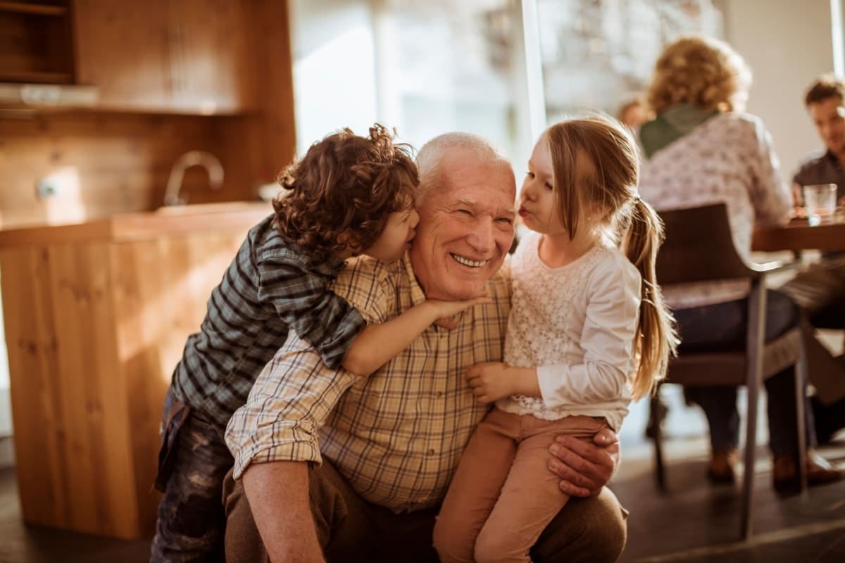 Resident being hugged by their grandchildren at Trustwell Living of Overland Park in Overland Park, Kansas