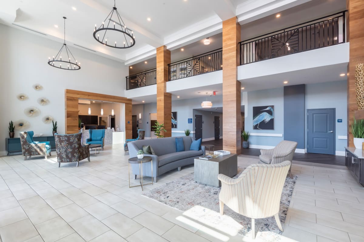 Modern lobby with seating and rustic black chandeliers at Trustwell Living of West Knoxville in Knoxville, Tennessee