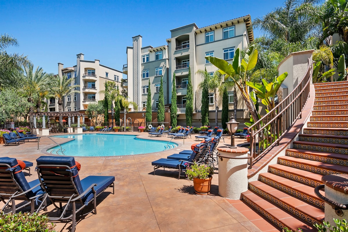 Resort-style pool with lounge chairs at Playa Del Oro, Los Angeles, California