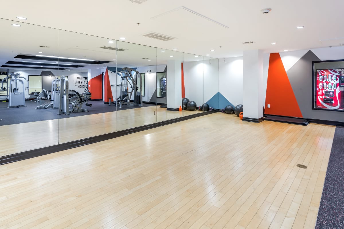 Fitness room with wood floor and large mirrors at Playa Del Oro, Los Angeles, California