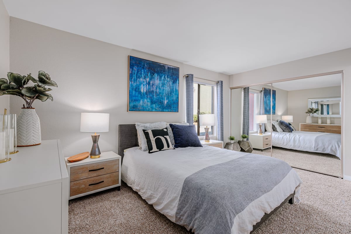 Model bedroom with blue accents at Reserve at South Coast in Santa Ana, California