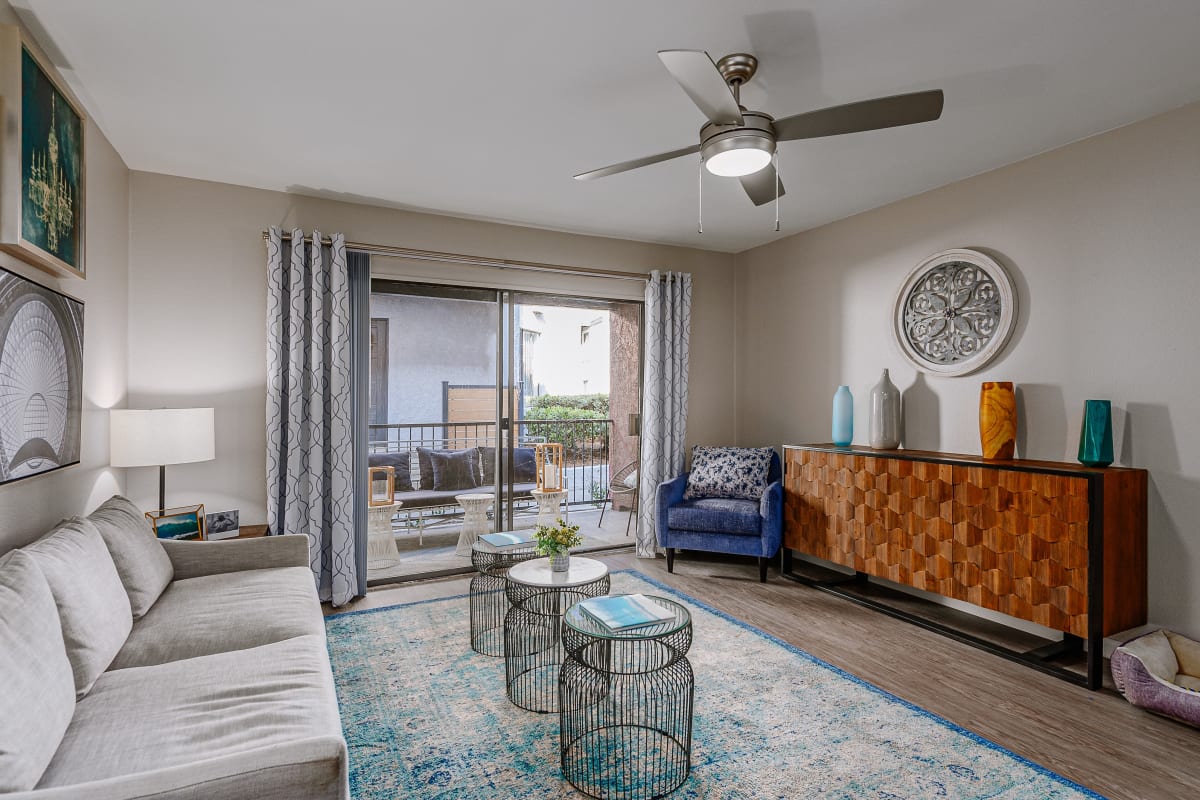 Model living space showing balcony at Reserve at South Coast in Santa Ana, California