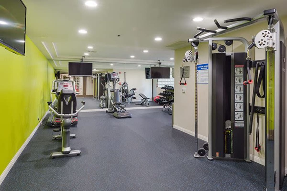 Fitness center with TV at The Joshua Apartments, Los Angeles, California