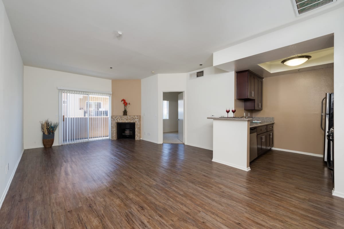 Spacious model apartment with wood-style flooring at The Joshua Apartments, Los Angeles, California