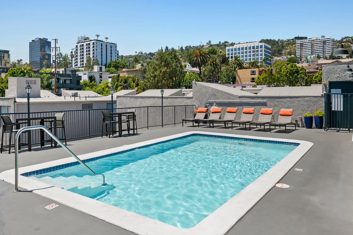 Resident pool with pool side chairs at Villa Francisca in West Hollywood, California