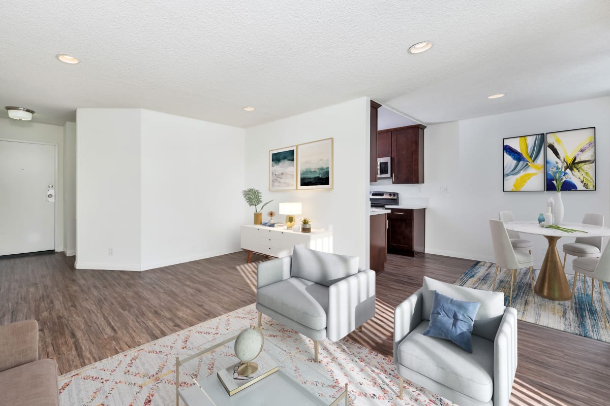 Living room with hardwood floors and a square area rug at Villa Francisca in West Hollywood, California