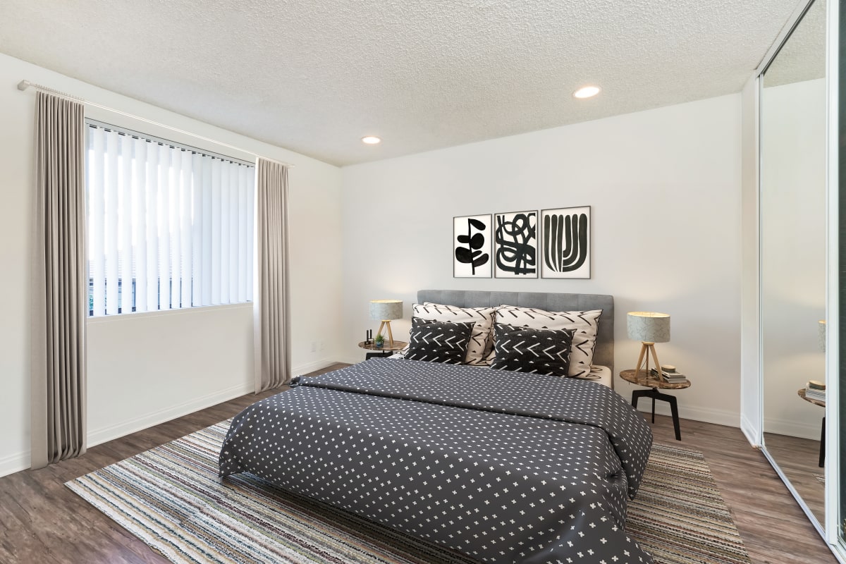 Master bedroom with a grey bedspread at Villa Francisca in West Hollywood, California