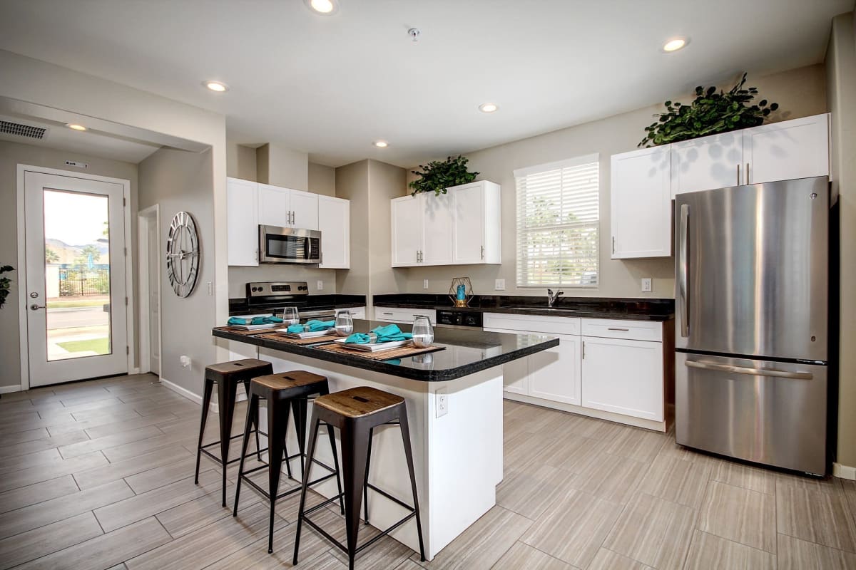 Kitchen with an island and wood-style flooring at The Reserve at Eastmark in Mesa, Arizona