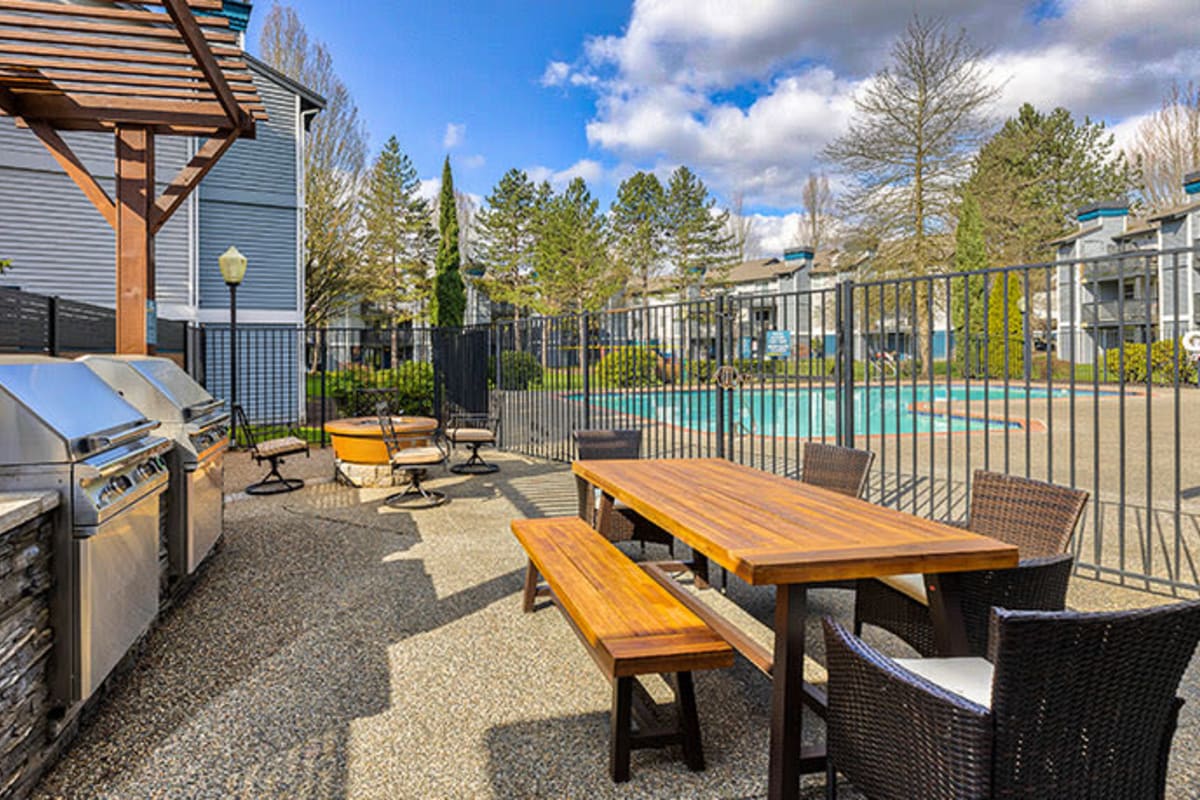 Outdoor grill station with chairs at The Retreat at Bothell, Bothell, Washington