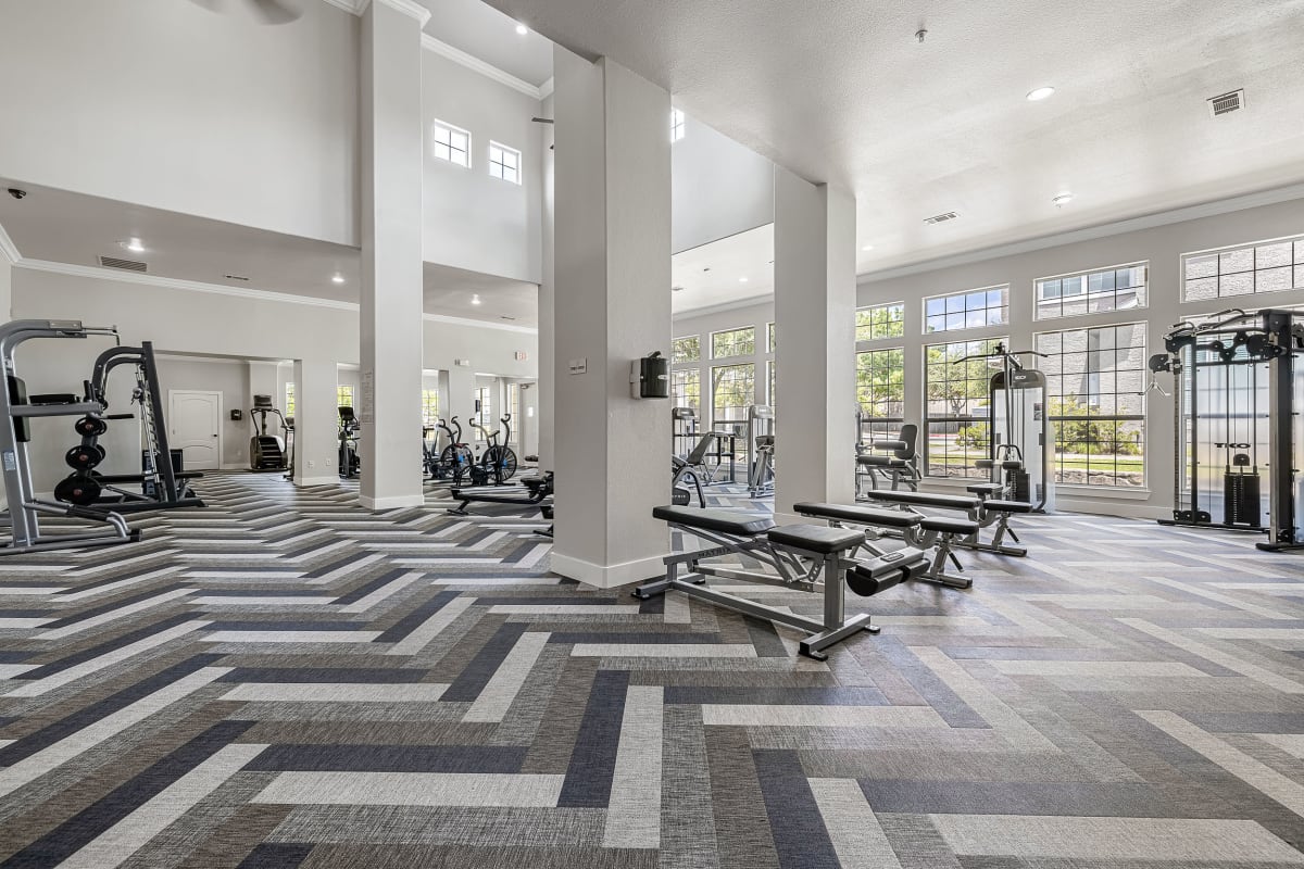 Elliptical machines and treadmills in fitness room at Marquis at The Cascades in Tyler, Texas