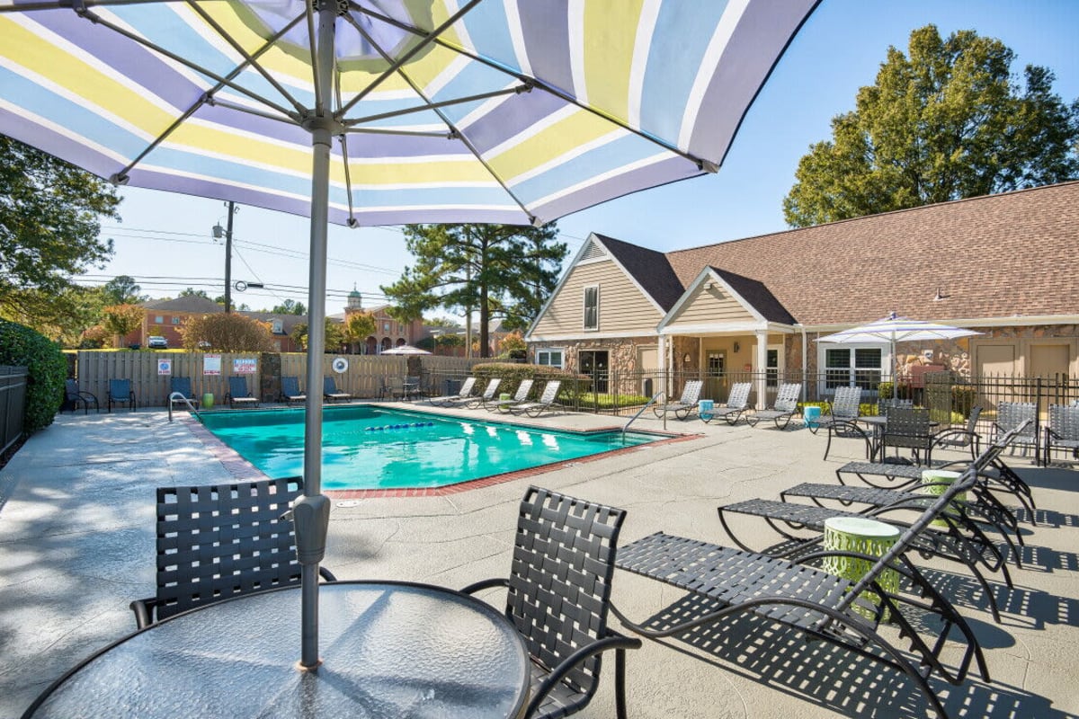 Swimming pool with umbrella at Farmington Gates in Germantown, Tennessee