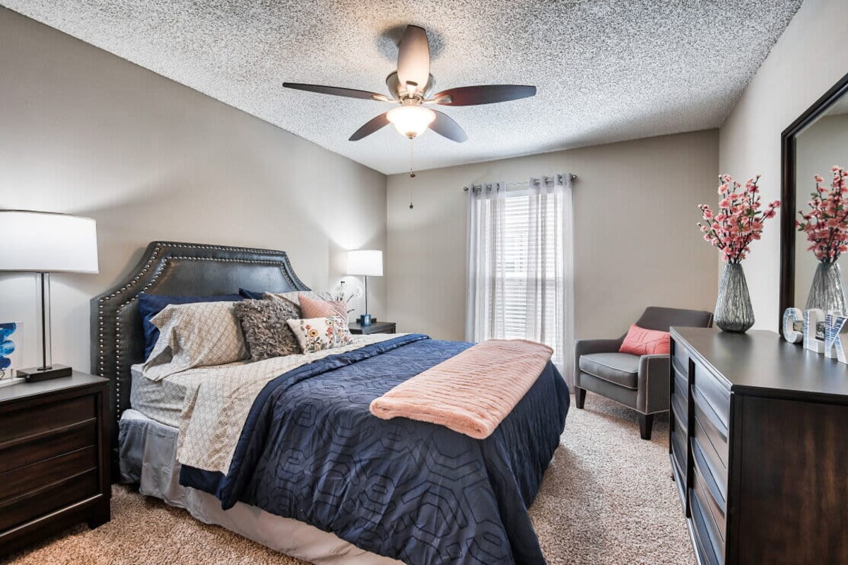 Model bedroom with ceiling fan at Farmington Gates in Germantown, Tennessee