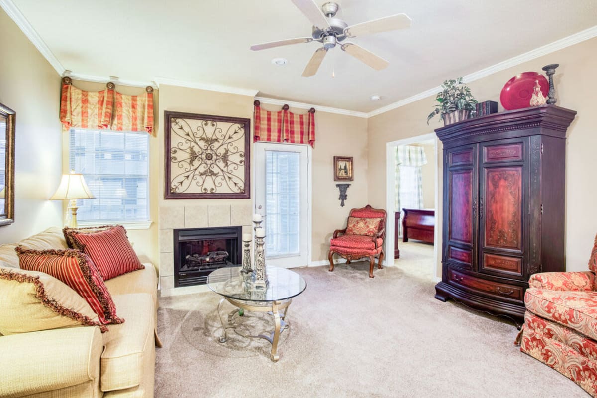 Model living space with ceiling fan at Villages of Cross Creek in Rogers, Arkansas