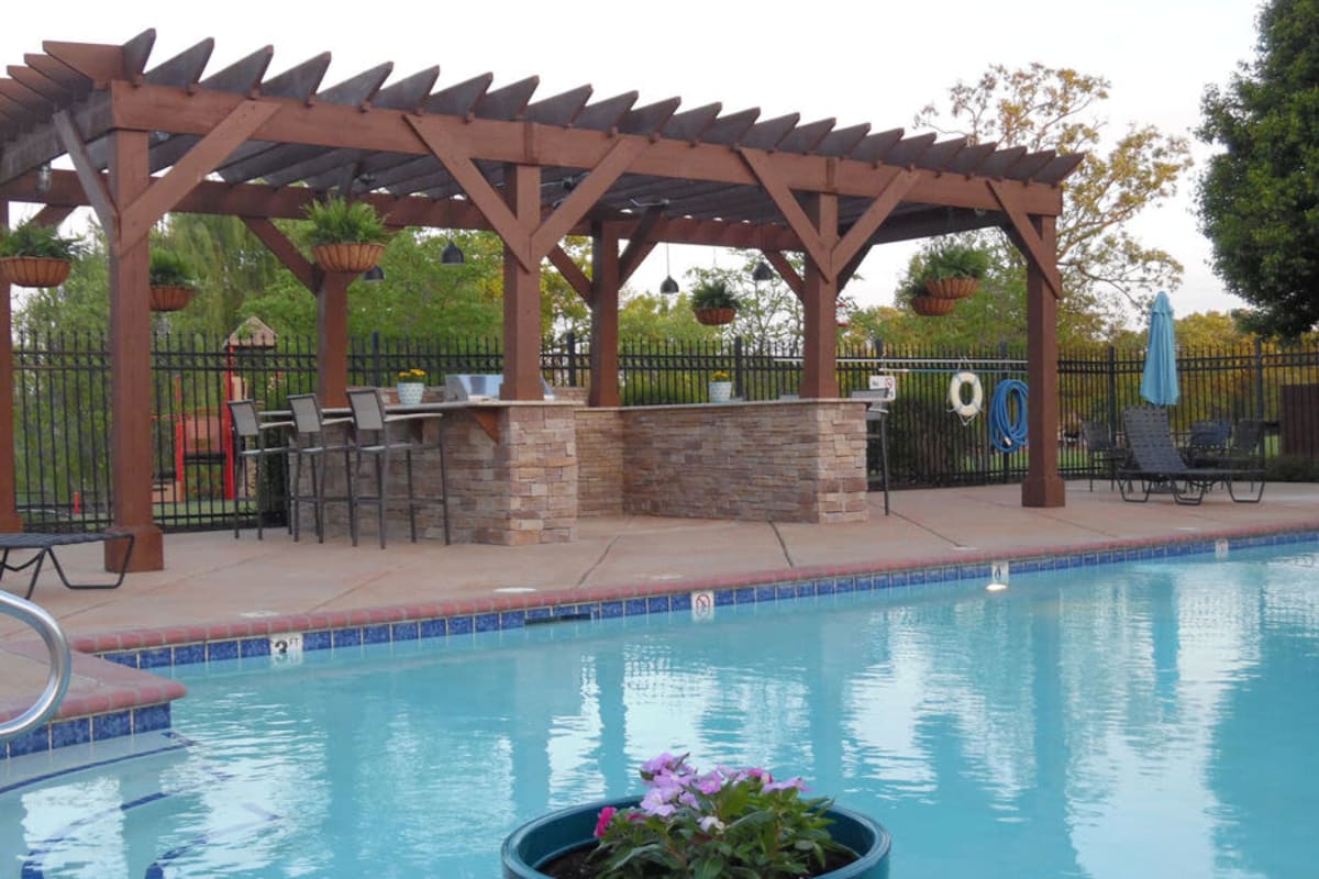 Swimming pool with seating at Villages of Cross Creek in Rogers, Arkansas