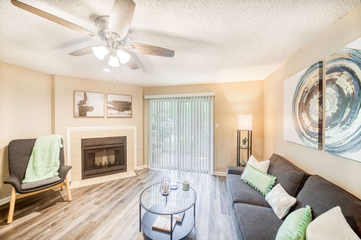 Model living space with ceiling fan at The Willows at Shelby Farms in Cordova, Tennessee