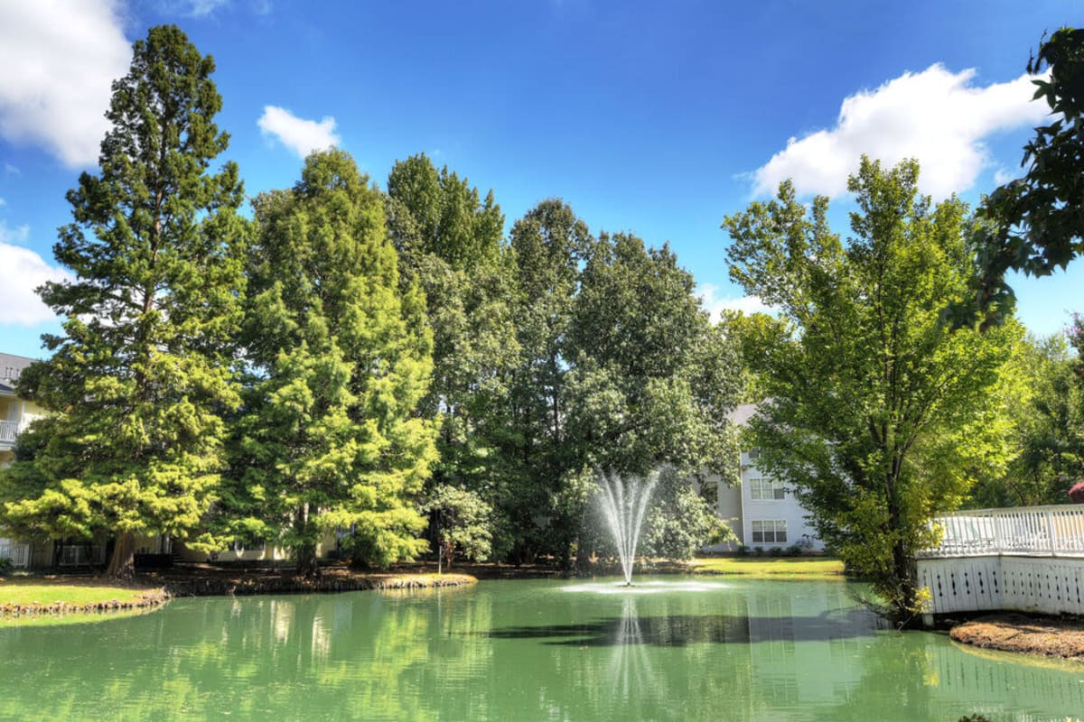 Well-landscaped pond with a fountain at The Willows at Shelby Farms in Cordova, Tennessee