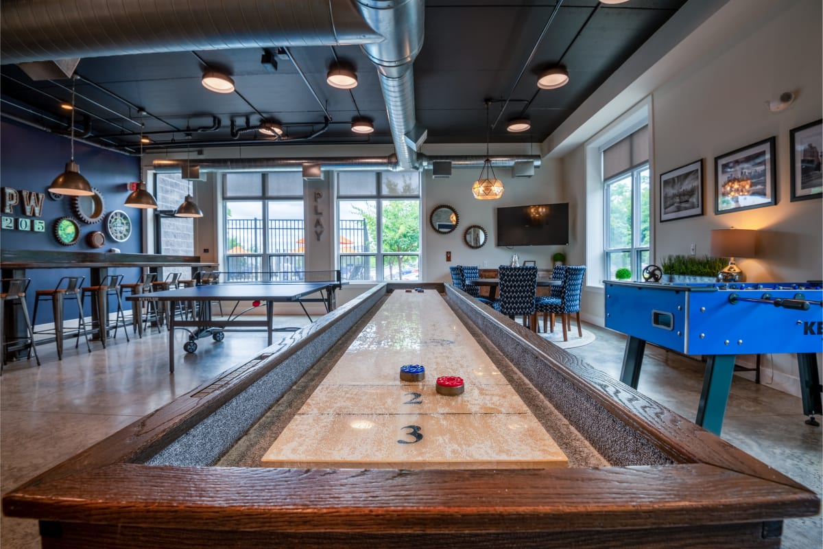 Clubhouse with shuffleboard and foosball tables at Park West 205 Apartment Homes in Pittsburgh, Pennsylvania