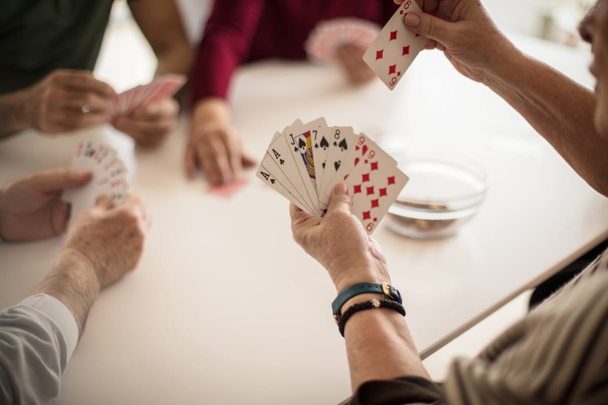 Residents playing a card game at Trustwell Living at Rogue River Place in Klamath Falls, Oregon