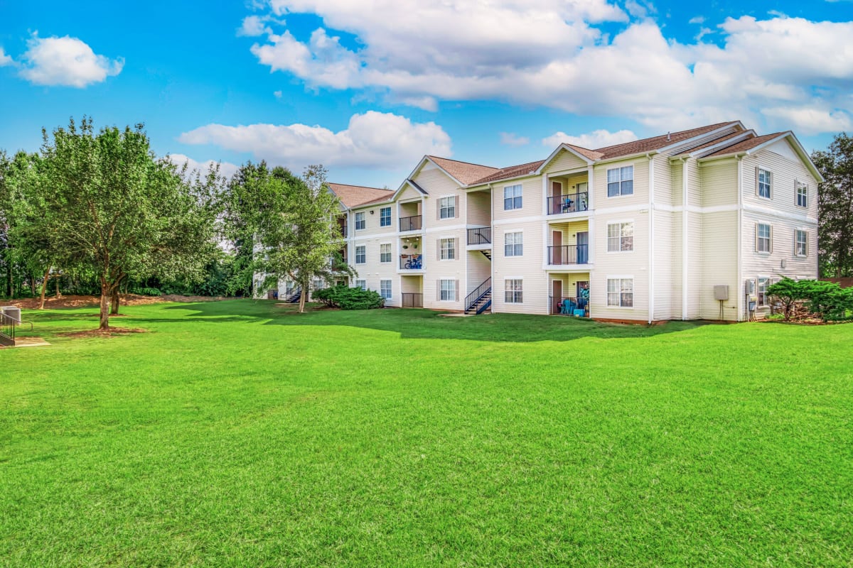 Exterior view of apartment building with great landscaping at Barrington Parc in Moody, Alabama