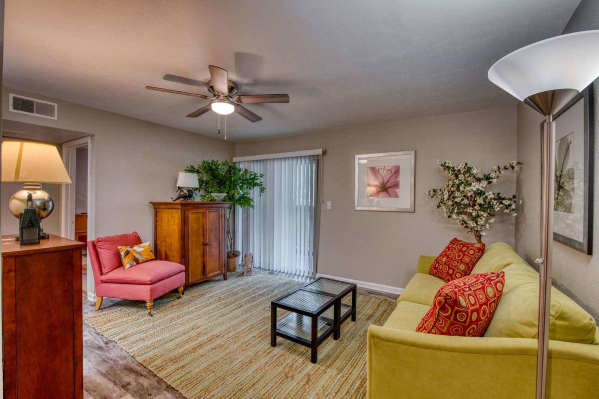 Resident living room with a ceiling fan at Lakes at Lincoln in Greensboro, North Carolina