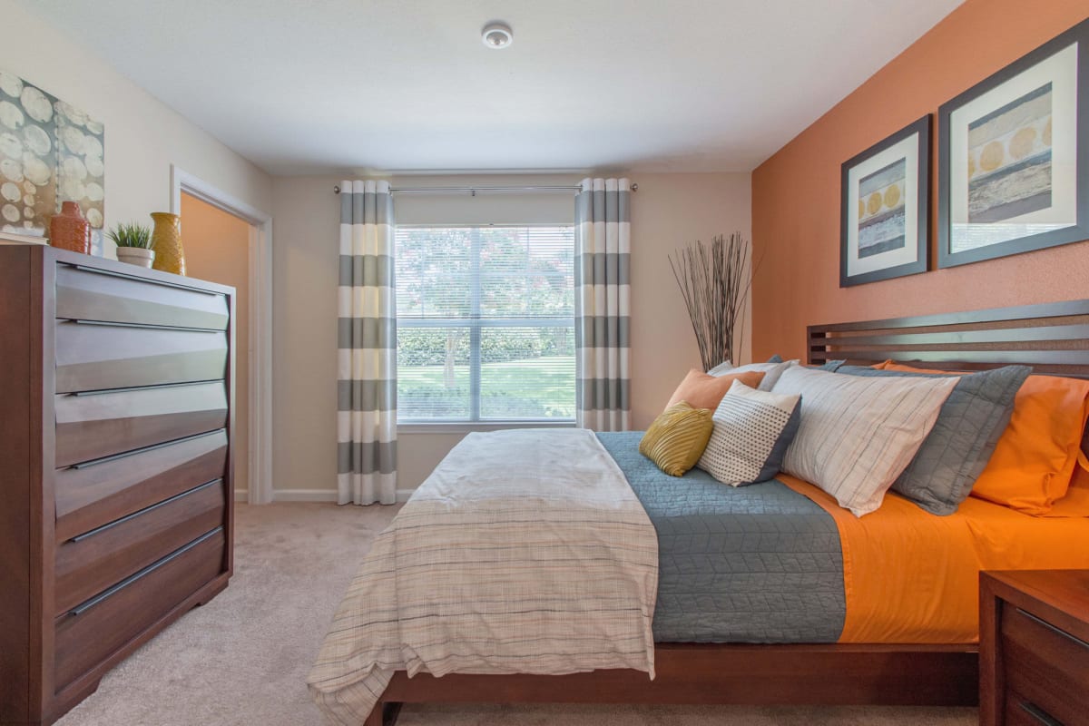 Resident bedroom with plush carpeting at Legacy Mill in Athens, Georgia