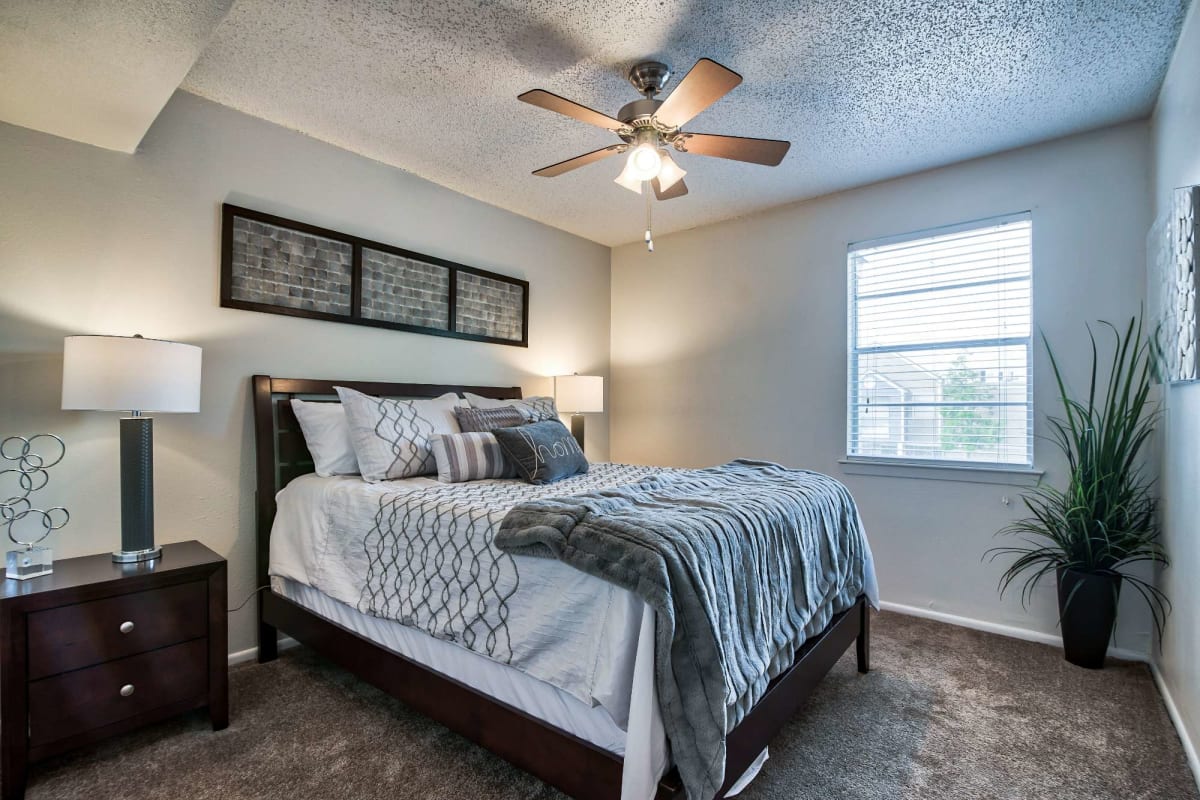 Master bedroom with plush carpeting at Cobblestone at Essen in Baton Rouge, Louisiana