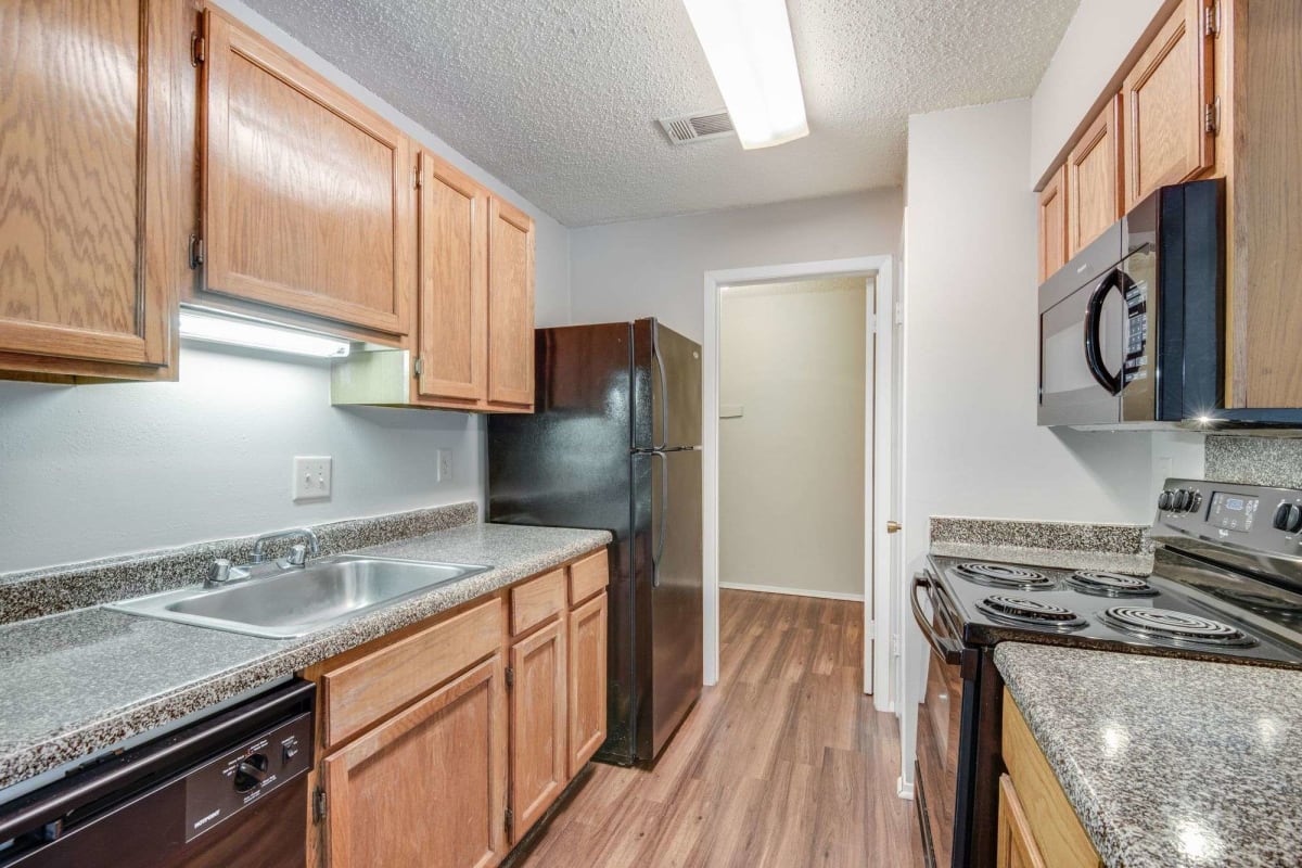 Another resident kitchen with wood-style flooring at Oakleigh Apartments in Baton Rouge, Louisiana