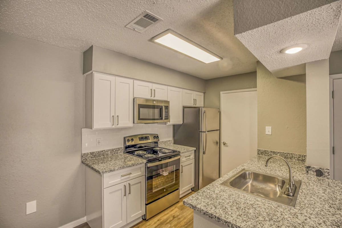 Resident kitchen with modern appliances at Atlas at Foresthaven in Baton Rouge, Louisiana