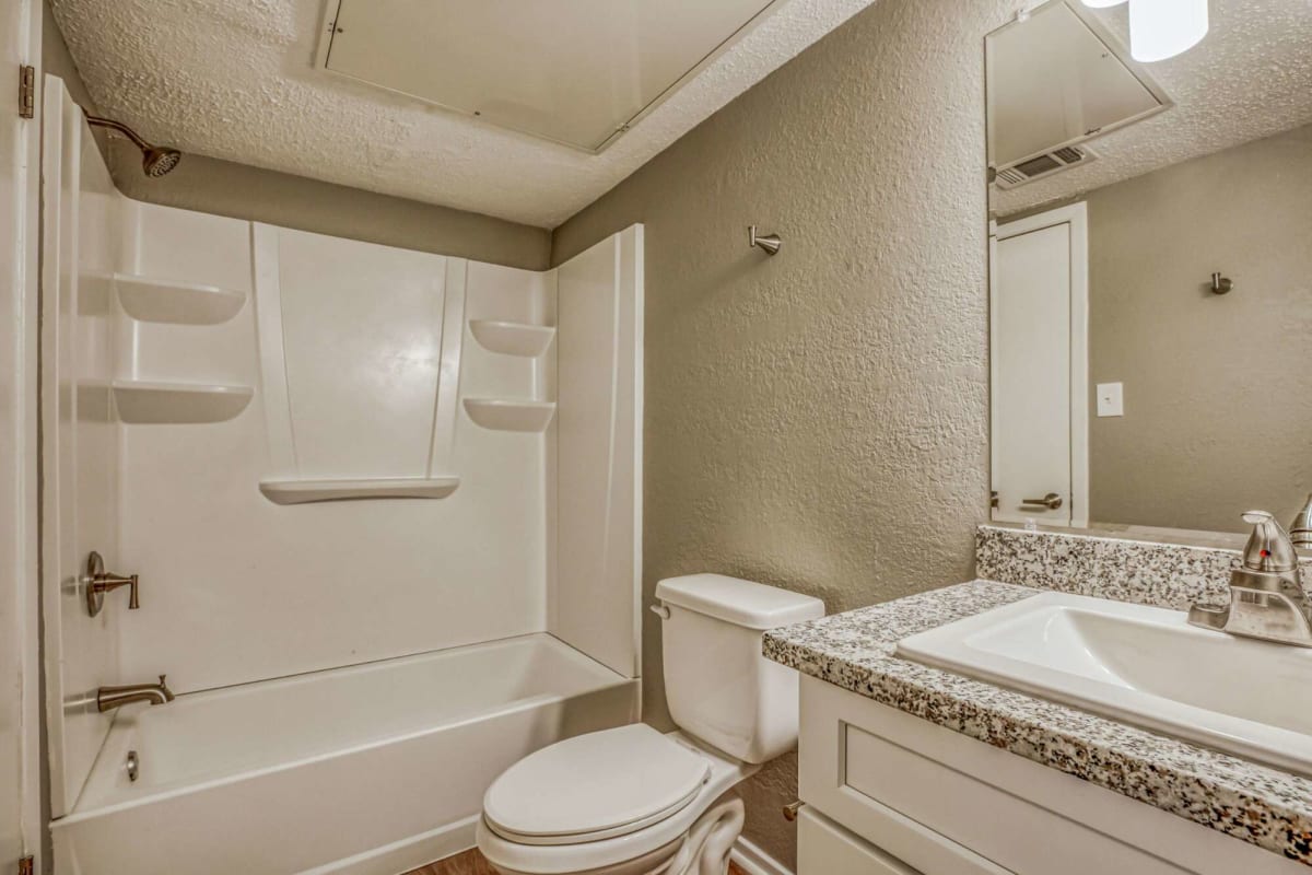 Resident bathroom with ample lighting at Atlas at Foresthaven in Baton Rouge, Louisiana