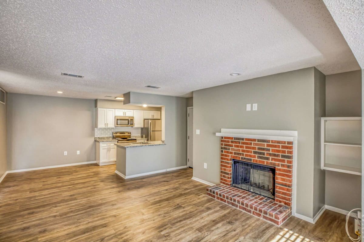 Fireplace and wood-style flooring at Atlas at Foresthaven in Baton Rouge, Louisiana