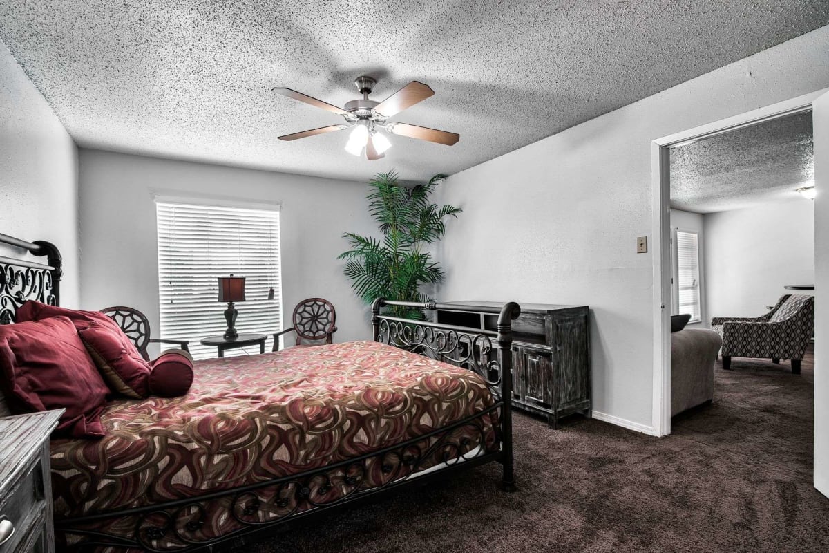 Resident bedroom with a ceiling fan at Sherwood Acres in Baton Rouge, Louisiana