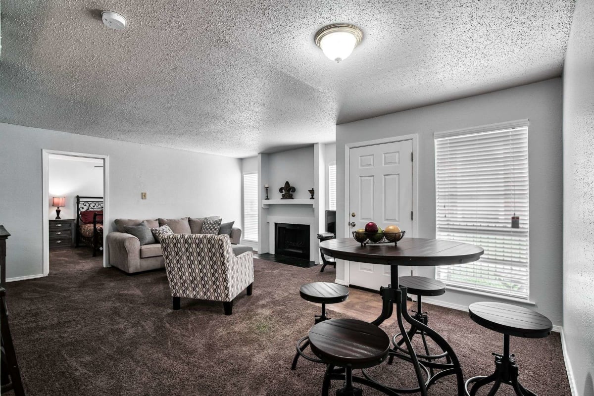 Resident living room with plush carpeting at Sherwood Acres in Baton Rouge, Louisiana