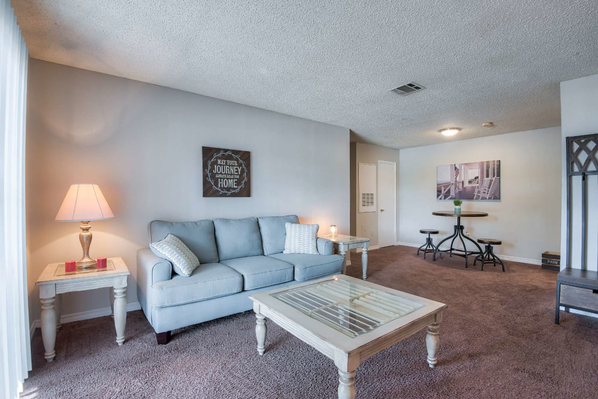 Living space with plush carpeting at St. Germaine in Harvey, Louisiana