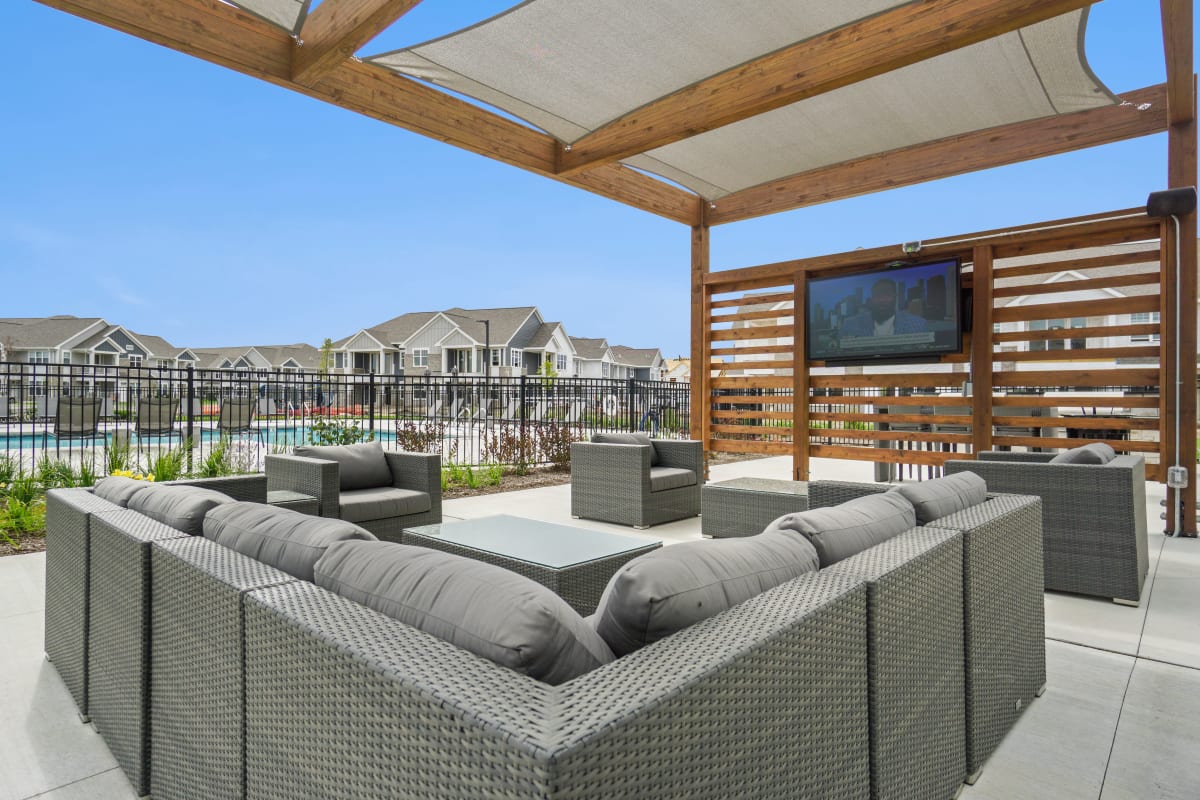 Outdoor clubhouse with seating and a tv at Seasons at North Aurora in North Aurora, Illinois