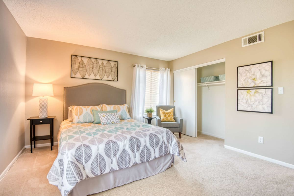 Resident bedroom with plush carpeting at Aspen Lodge in Overland Park, Kansas