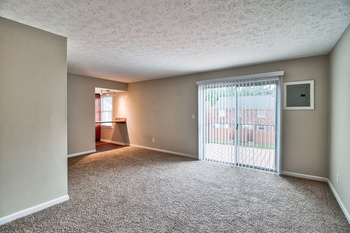 Open resident living space with plush carpeting at Charlestown of Douglass Hills in Louisville, Kentucky