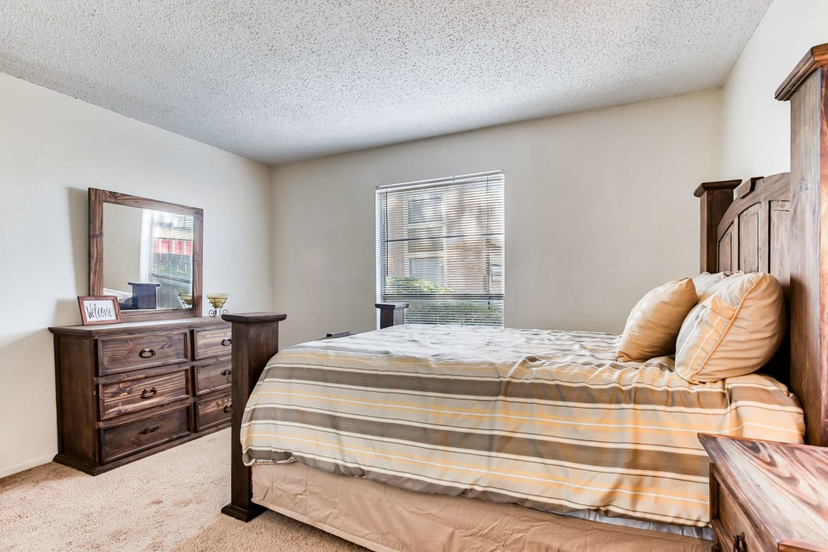 Resident bedroom with plush carpeting at Creekside in San Angelo, Texas
