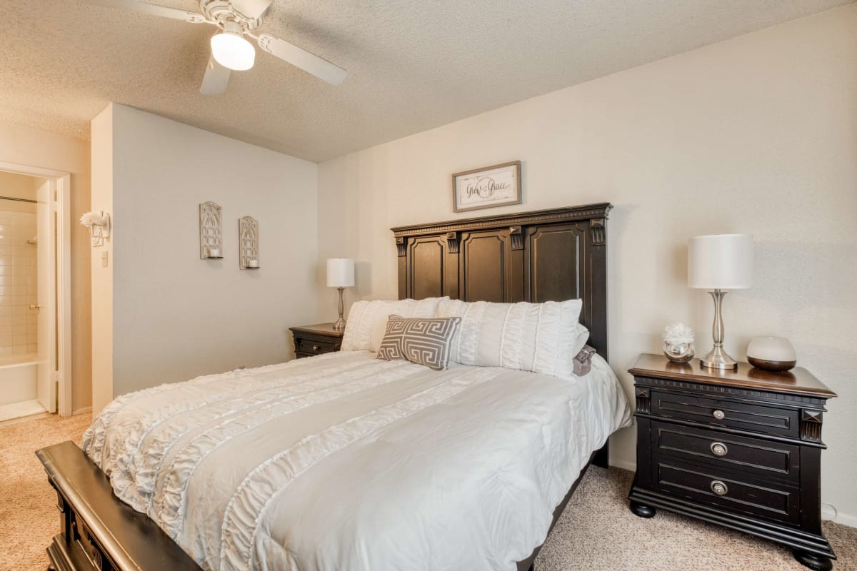 Resident bedroom with plush carpeting at Hunters Glen in Killeen, Texas