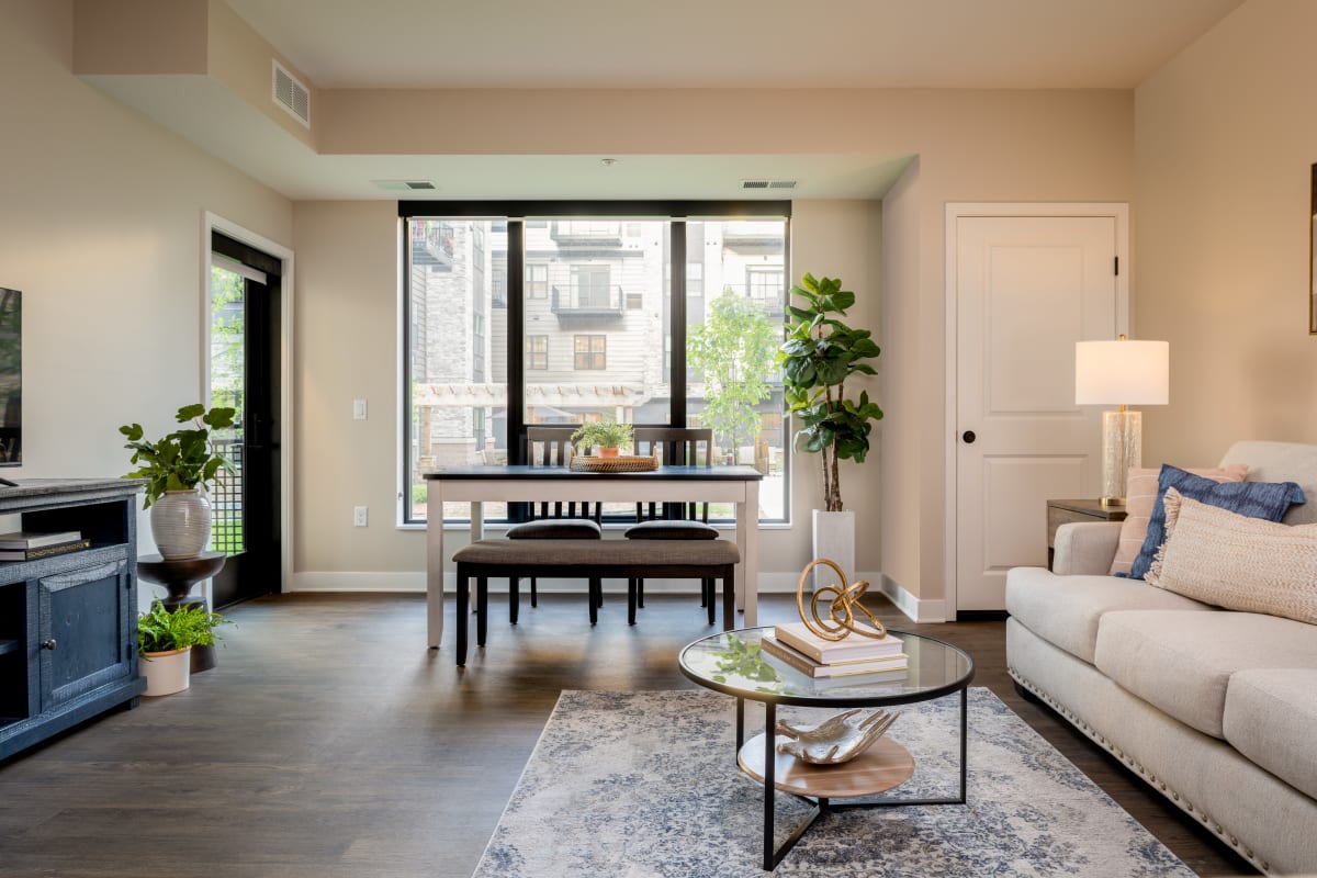 Bedroom furnished with bed, nightstands, and draped windows in a model senior apartment at Amira Lake Elmo in Lake Elmo, Minnesota