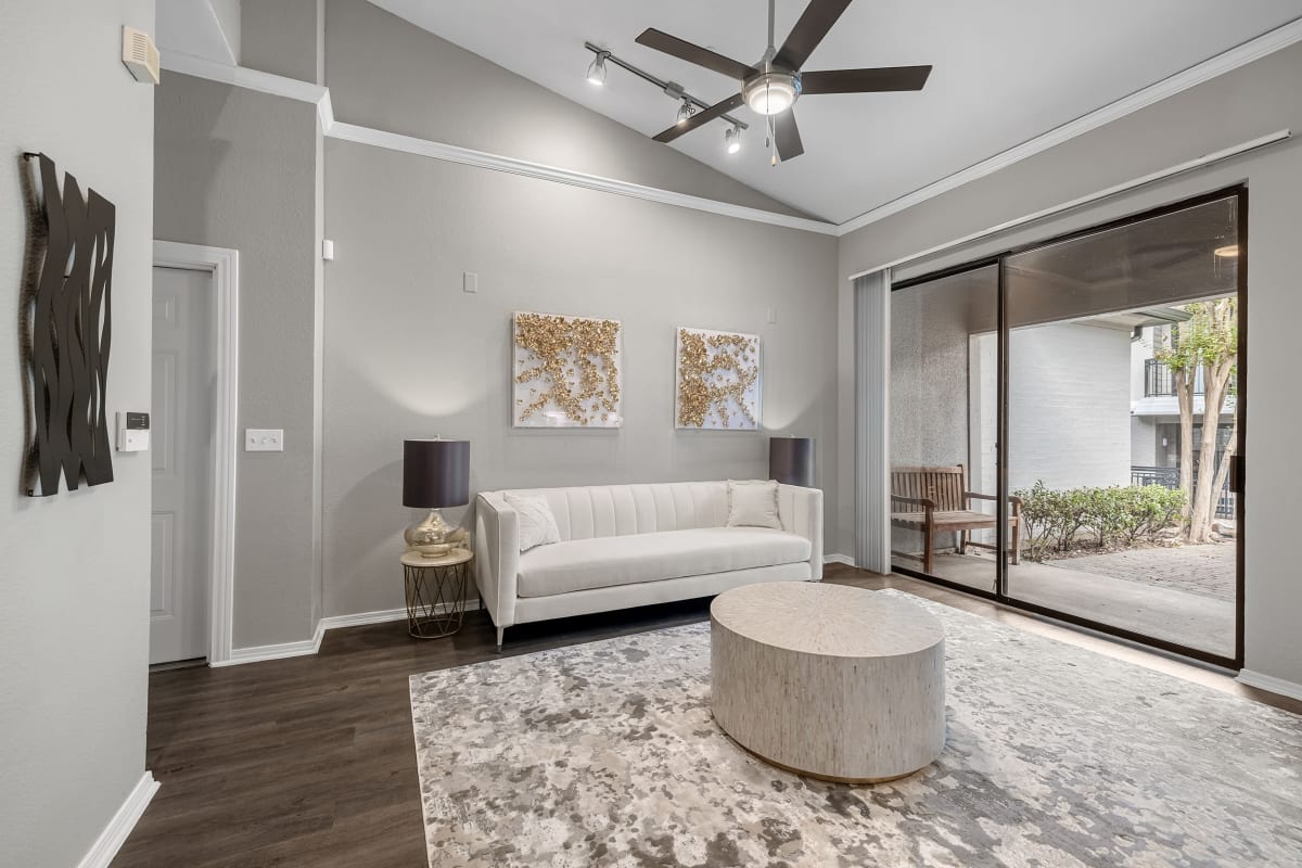 Bright and open living room with vaulted ceilings and wood flooring at Marquis at Waterview in Richardson, Texas