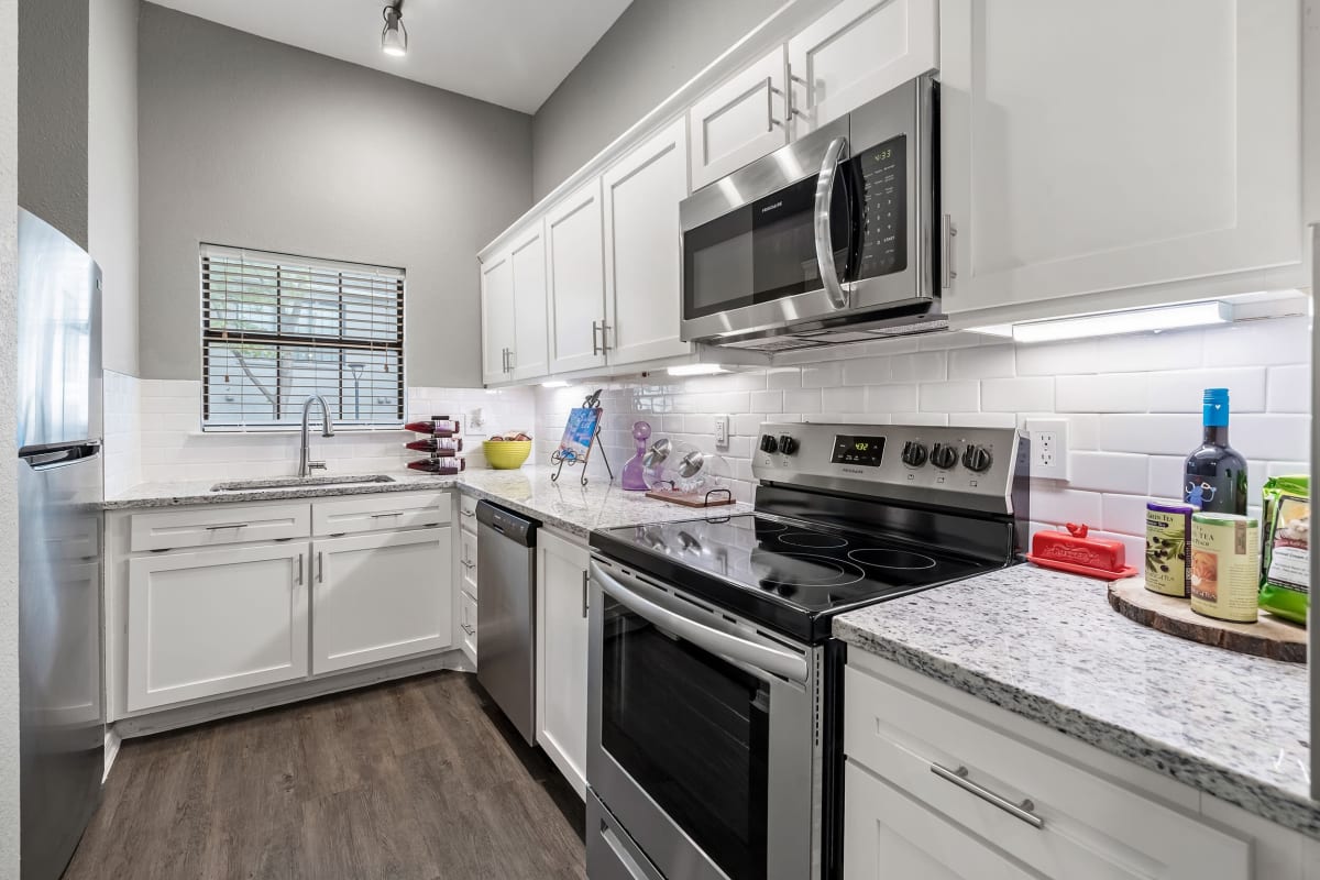 Kitchen with white cabinets at Marquis at Waterview in Richardson, Texas 